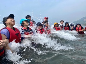Water safety program: Trainees experience the force of tidal waves. All of them are wearing life vests.(Open new window/jpg file)